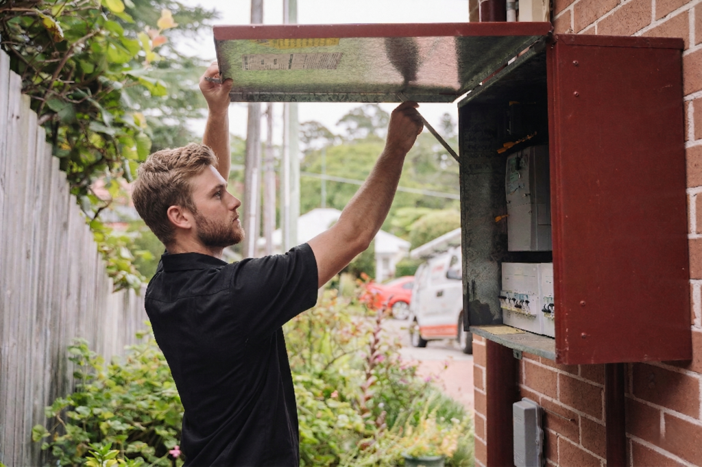 Electrician installing downlights in a Five Dock home